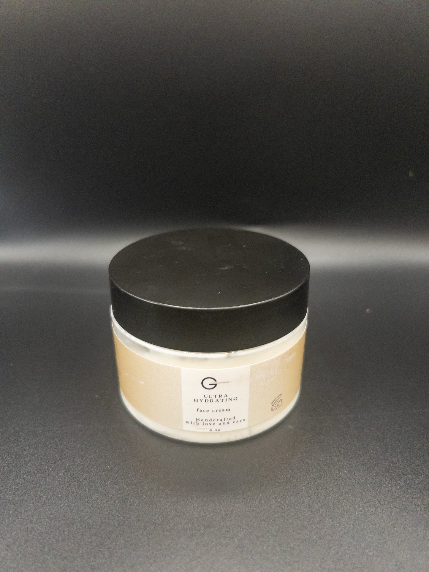 Picture of a 4 oz jar of a glow facial moisturizer called ultra hydrating face cream. Jar is sitting on a black background. Good moisturizers for seborrheic dermatitis.