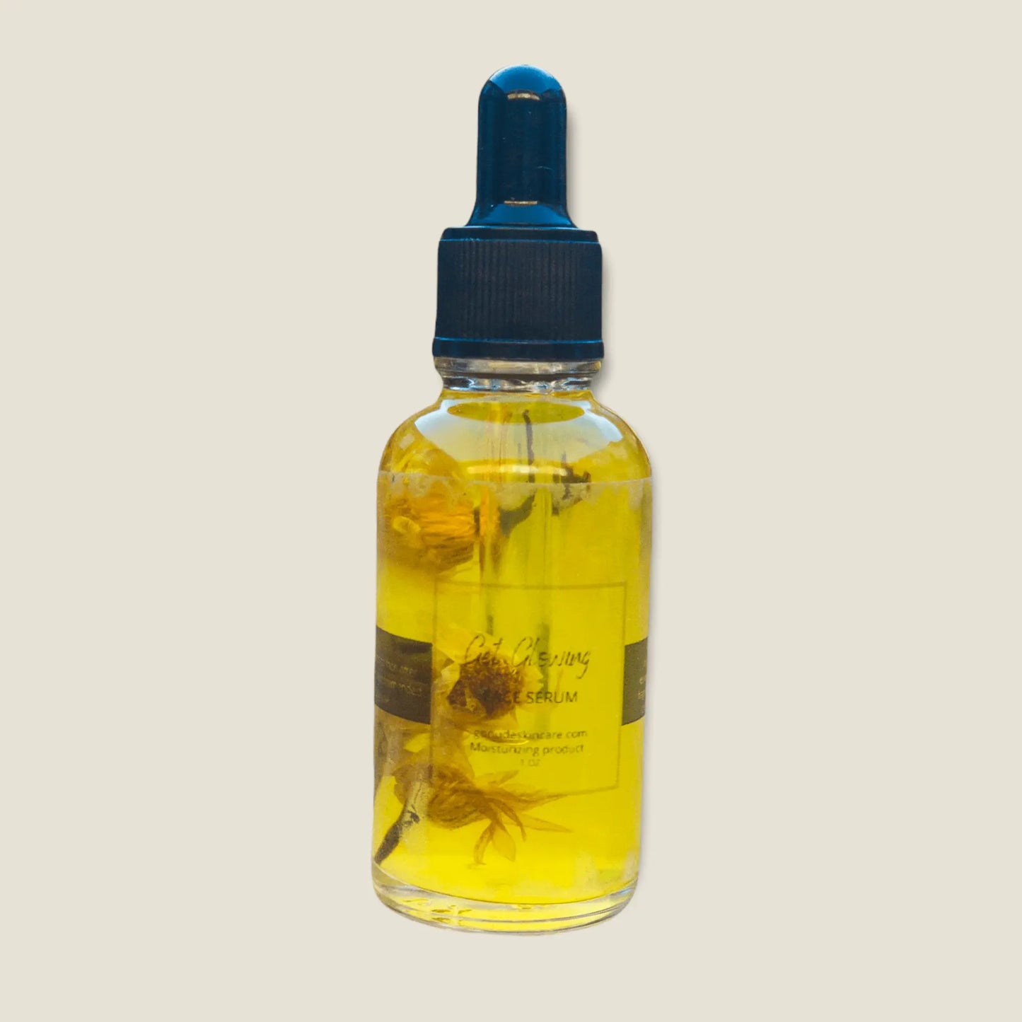 Picture of 1 ounce dropper bottle of glowing facial moisturizer serum on a gray background.